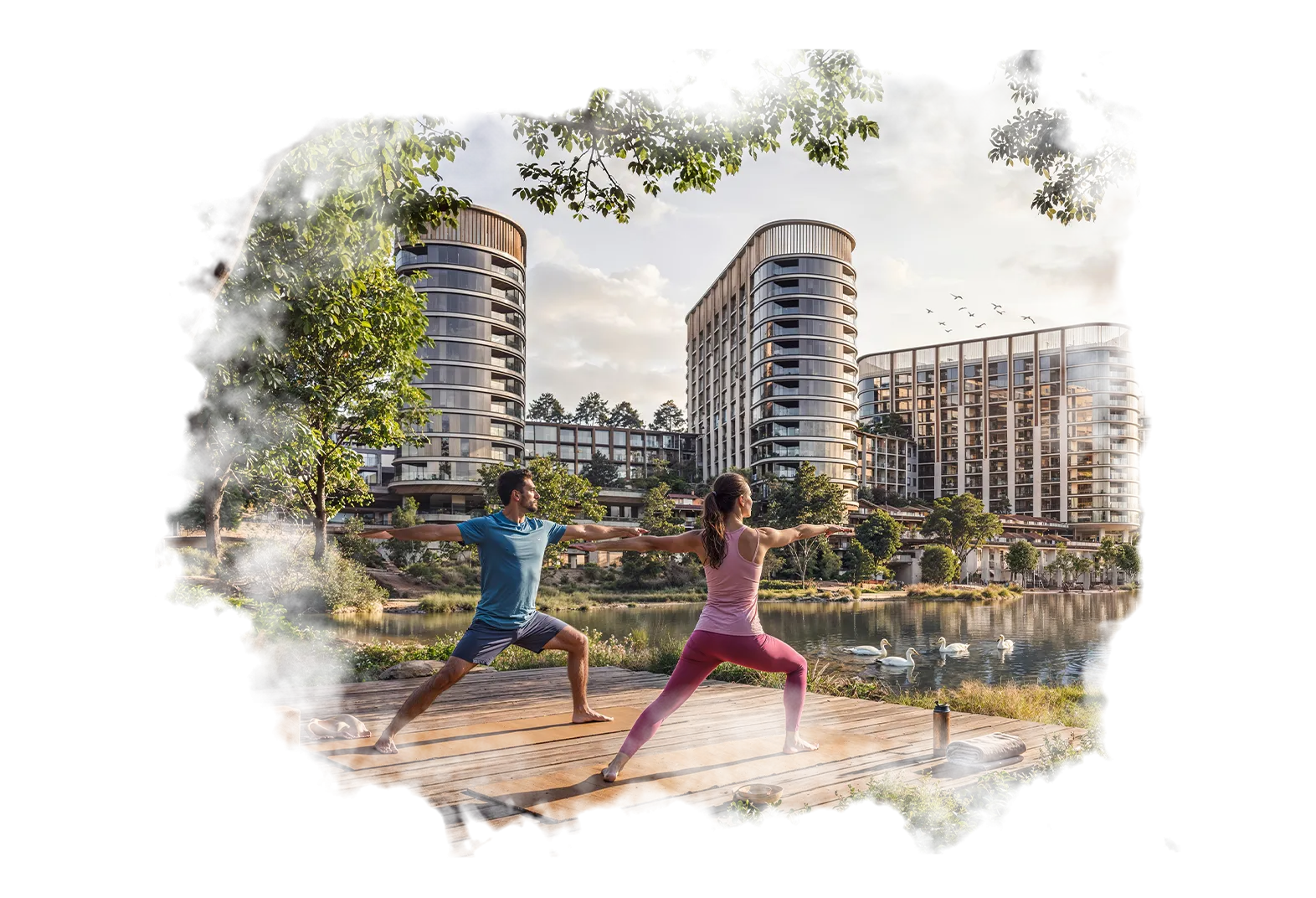 A serene outdoor seating area with two chairs, surrounded by lush greenery and a glassed-in structure.
